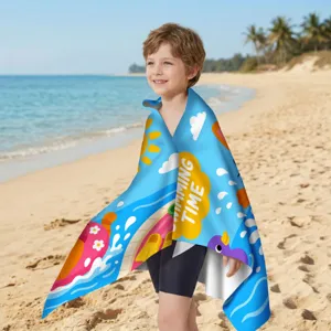 Kind am sonnigen Strand mit einem blauem Mikrofaser-Strandtuch und Schwimmzeit-Grafiken