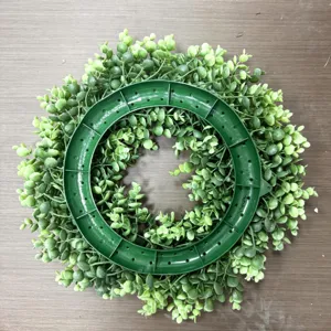 Detailed back view of artificial green eucalyptus leaf wreath with plastic frame