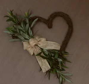Rustic heart-shaped twig wreath with artificial olive branches and a burlap bow decoration