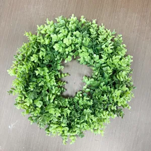Close-up of a lush green artificial money leaf wreath for front door decor