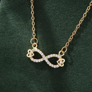 Gold infinity heart necklace with sparkling cubic zirconia, elegant minimalist jewelry gift.