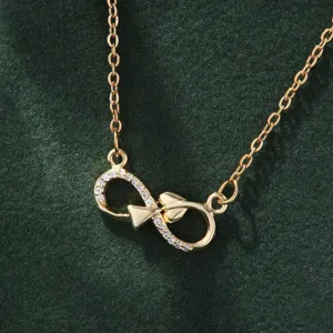 Elegant gold infinity symbol necklace featuring sparkling cubic zirconia stones and delicate chain.