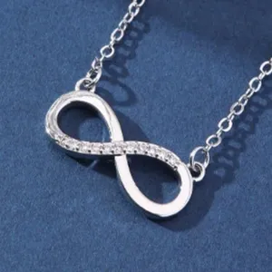 Exquisite detail shot of the silver infinity symbol pendant necklace with sparkling micro-set zircons.