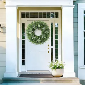 Lush green eucalyptus and boxwood wreath with white flowers for front door decoration
