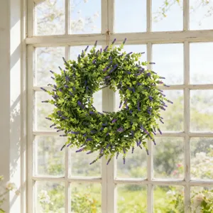 Artificial lavender and boxwood wreath hanging on a rustic white wooden window frame