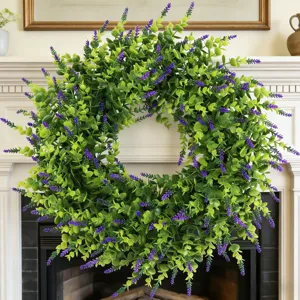 Close-up view of a lush artificial lavender and boxwood wreath on a white mantelpiece
