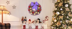 Detailed view of purple lavender wreath with red gold Christmas balls and large purple bow