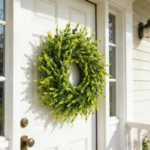 Lush artificial lavender boxwood wreath displayed on a white front door for home decor.
