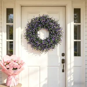 Large artificial purple lavender wreath displayed on a white front door for home decor