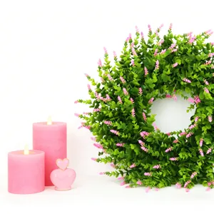 Artificial lavender and boxwood wreath paired with decorative pink candles