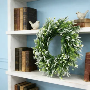Detailed view of lush artificial lavender wreath on a rustic white shelf.