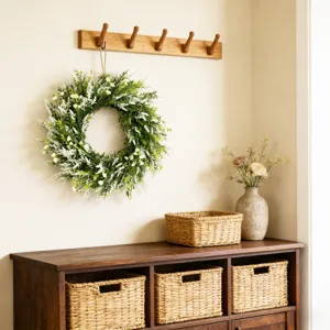 Lush spring green wreath with white flowers hanging in a cozy home entrance scene