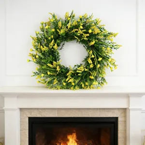 Beautiful yellow floral spring wreath displayed on a classic white fireplace mantel decor