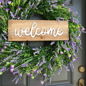 Detailed close-up view of a purple lavender wreath with a rustic wooden welcome sign