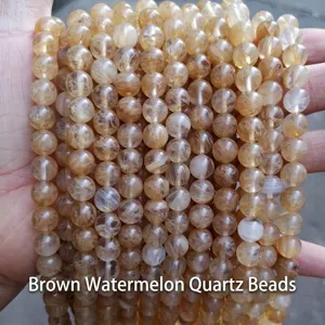 Macro view of multiple strands of coffee-colored synthetic watermelon crystal round beads