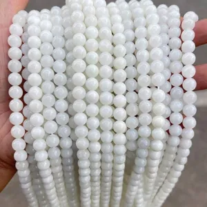 Close-up of polished white round jade beads for DIY jewelry making and craft