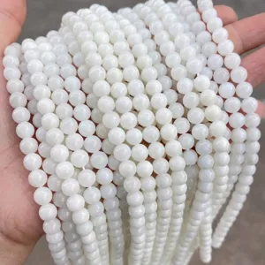Macro detail of high-quality polished white jade round beads for DIY jewelry making accessories