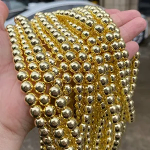 Detailed view of polished electroplated gold hematite round beads for DIY jewelry
