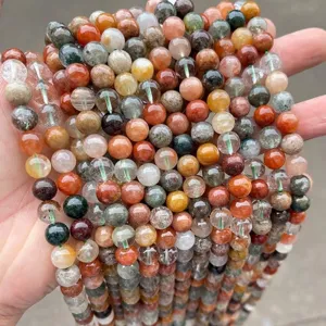 Close-up of natural phantom quartz beads showing colorful inclusions and clear texture