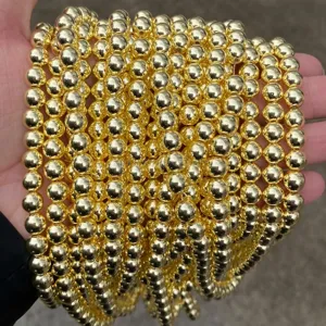 Macro view of shiny gold-plated hematite round beads strands for DIY jewelry making