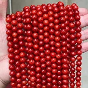 Gros plan détaillé de perles rondes en calcédoine rouge pour la création de bijoux DIY