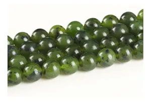 Macro detail of natural Canadian nephrite jade beads with dark mineral speckles