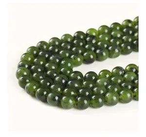 Close-up of natural Canadian nephrite jade round beads with dark mineral spots