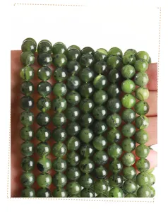 Macro view of natural Canadian green jade round beads for jewelry making