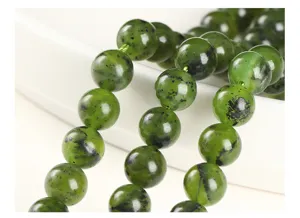 Macro view of natural Canadian green jade beads with unique dark patterns and textures