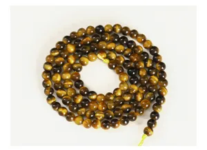 Detailed macro view of high quality natural yellow tiger eye round beads for DIY jewelry