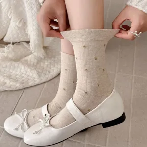 Cute floral mid-tube socks detail shot, cozy beige knit fabric with delicate flower patterns.