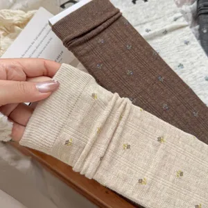 Detail view of Korean style floral ribbed mid-calf socks, cozy knit texture, soft fabric.