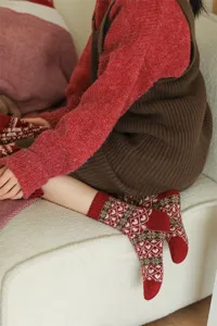 Detail shot of retro Fair Isle patterned wool socks in red, showcasing cozy winter knit texture.