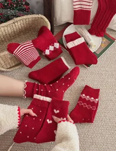 Red thickened wool mid-calf socks with cute heart dot stripe designs for warm winter wear.