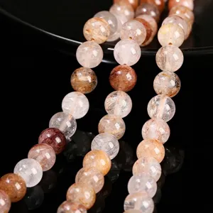 Natural red rutilated quartz round beads for DIY jewelry making on black background