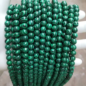 Macro detail of synthetic malachite beads showing green and black banding patterns