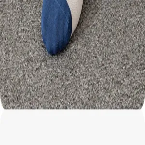 Close-up detail of blue and white striped men socks on textured gray carpet surface.