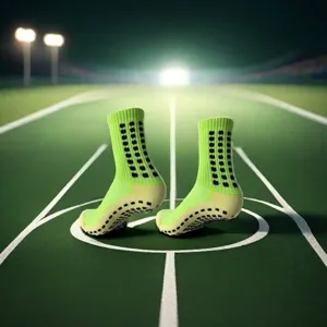 Detailed shot of neon green football grip socks with rubber dots on field under stadium lights.