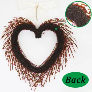 Detail view showing the back structure of a handmade heart-shaped twig wreath with pink buds.