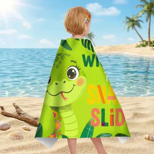 Kind trägt ein grünes Mikrofaser-Strandtuch mit einer Schlange an einem Strand