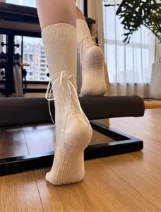 Ballet style yoga socks with ribbon bow and anti-slip grip sole for women pilates workouts.