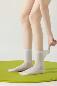 Close-up detail of women's thin translucent mid-tube summer socks showing breathable fabric texture.
