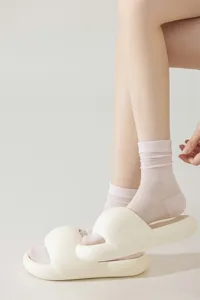 Close-up of translucent thin silk mid-tube socks in soft pink, breathable summer daily wear.