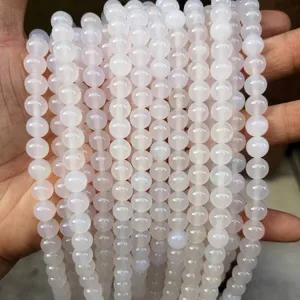 Close-up detail of premium 8mm white agate round beads for DIY jewelry accessories.