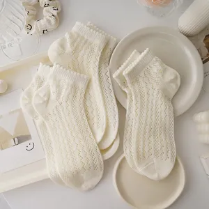 Detail view of Japanese sweet hollow-out mesh socks with delicate lace ruffles for women.