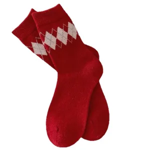 Cozy red wool mid-tube socks with classic argyle pattern for winter warmth and daily wear.