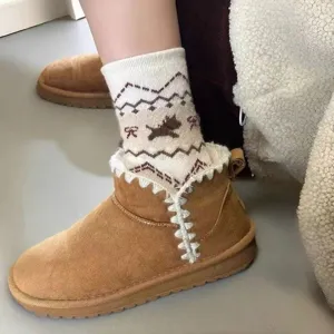 Detail shot of winter thermal knit socks with cute puppy and bow pattern paired with cozy boots.