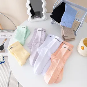 Women cotton mid-calf socks with heel letters, cute pastel slouch socks for autumn winter daily wear.