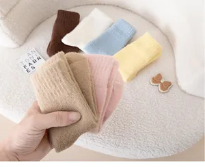 Cozy plush kids winter socks detail close-up, soft coral fleece warm mid-tube socks in multi colors.