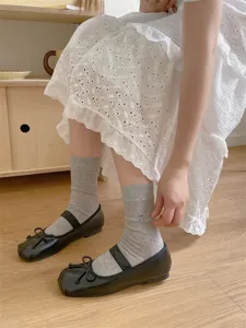 Japanese style bow mid-calf socks paired with black Mary Jane shoes for summer daily wear.